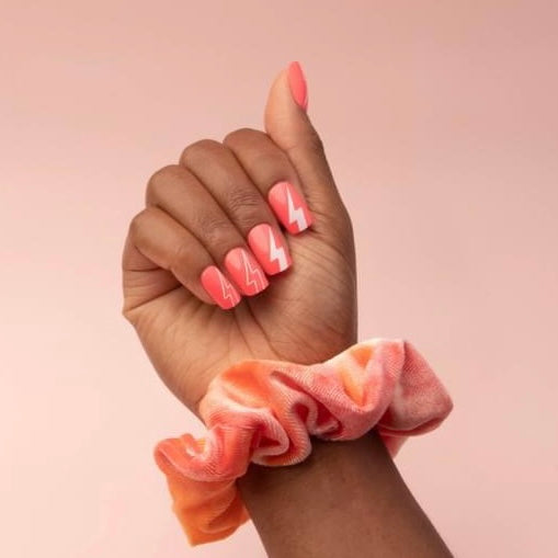 Bright pink nails with lightning bolt decoration
